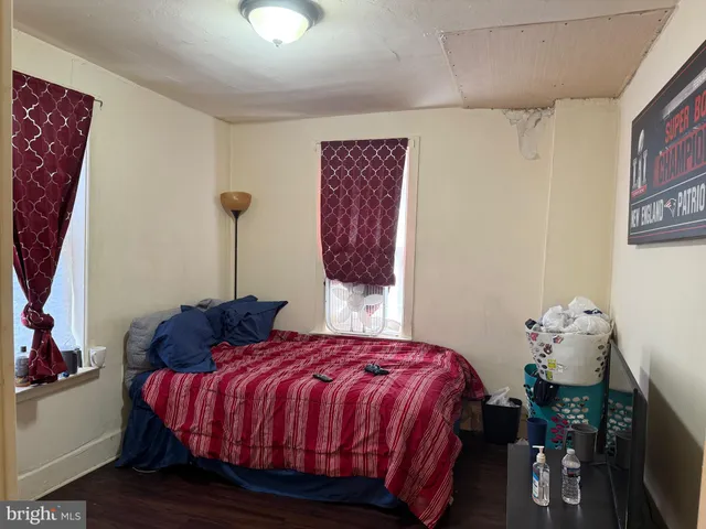 a bedroom with bed and a window