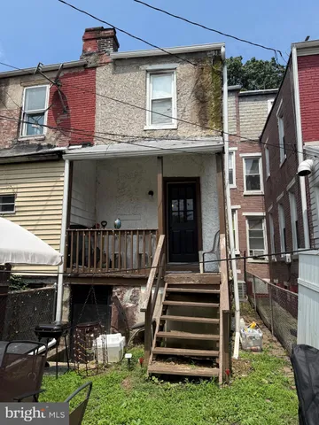 a view of a chairs and table in backyard