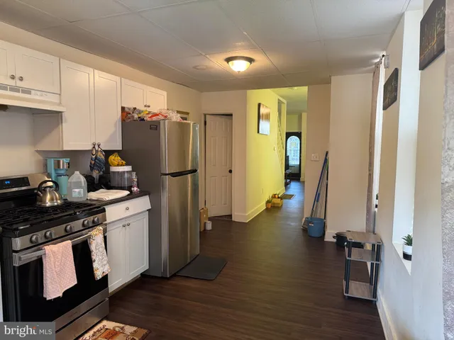 a kitchen with a refrigerator and a stove