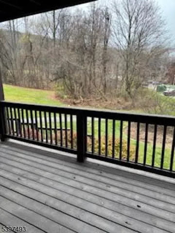a view of a balcony with wooden floor