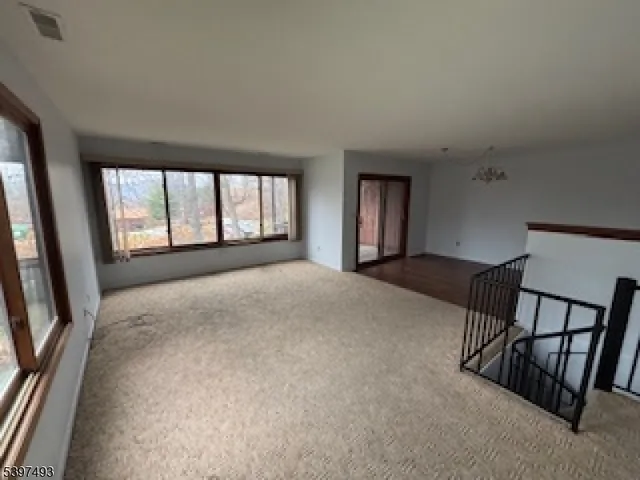 a view of a kitchen with furniture and an empty room