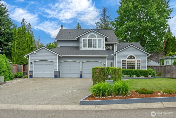 a front view of a house with a yard and garage