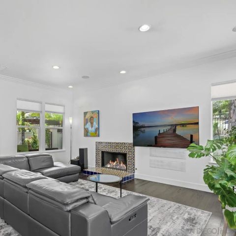 a view of a kitchen with furniture and wooden floor