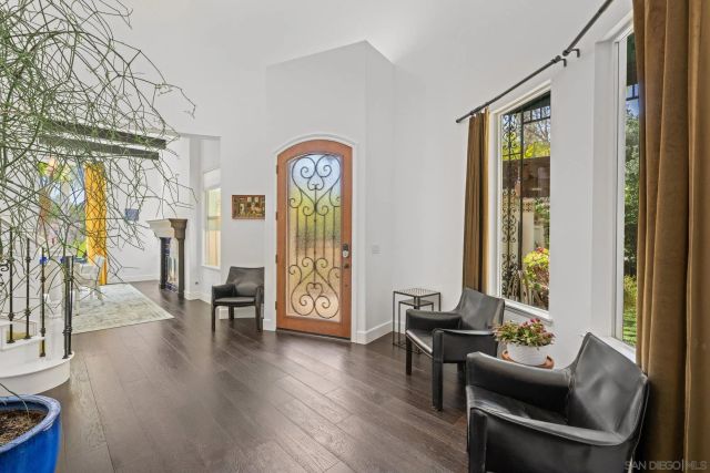 a kitchen with stainless steel appliances kitchen island granite countertop a stove a sink a dining table and chairs