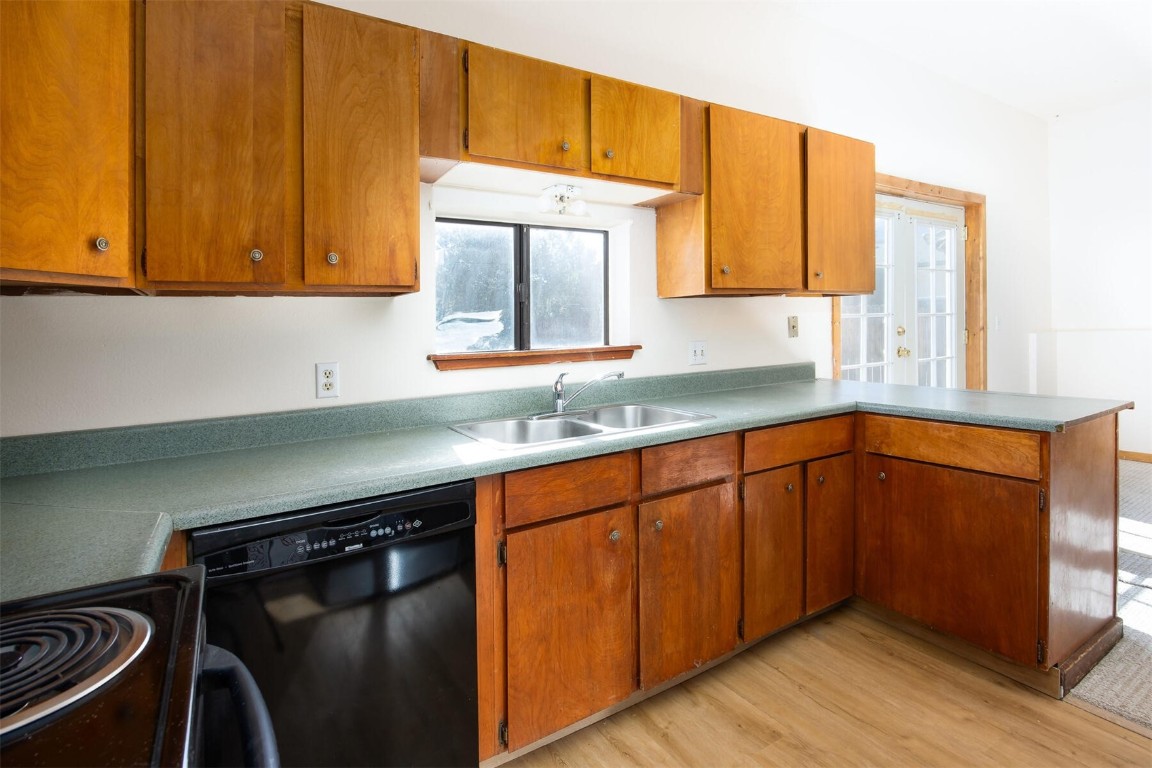 420 Reese Road Silverthorne, CO 80498 - Photo 36 of 50 a kitchen with stainless steel appliances granite countertop a sink cabinets and a wooden floor