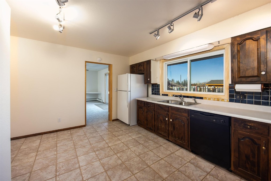 420 Reese Road Silverthorne, CO 80498 - Photo 8 of 50 a kitchen with stainless steel appliances a sink and cabinets