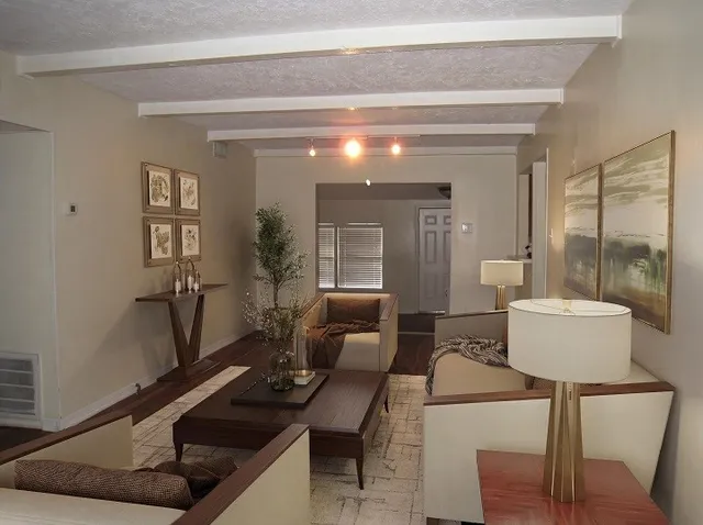 a living room with furniture and wooden floor