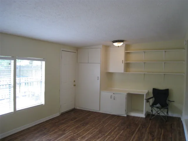 a workspace with wooden floor and a window