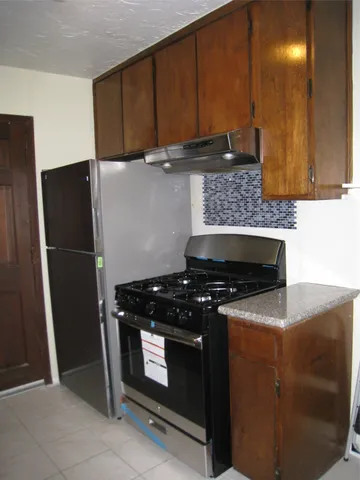 a kitchen with a stove microwave and refrigerator