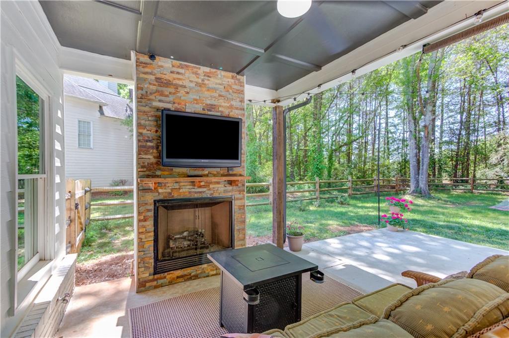 2310 Olde Hickory Place Monroe, GA 30656 - Photo 30 of 46 a living room with fireplace and a floor to ceiling window