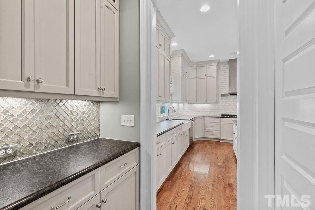 516 Sasser Street Raleigh, NC 27604 - Photo 11 of 30 a kitchen with granite countertop white cabinets and white appliances