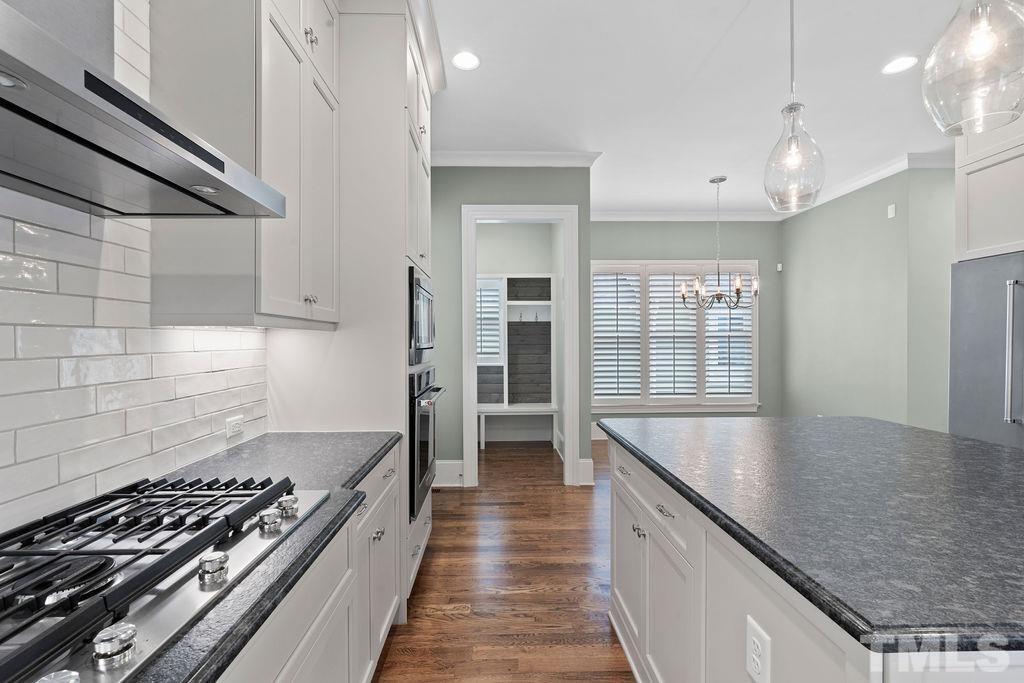516 Sasser Street Raleigh, NC 27604 - Photo 14 of 30 a kitchen with granite countertop a stove and a sink