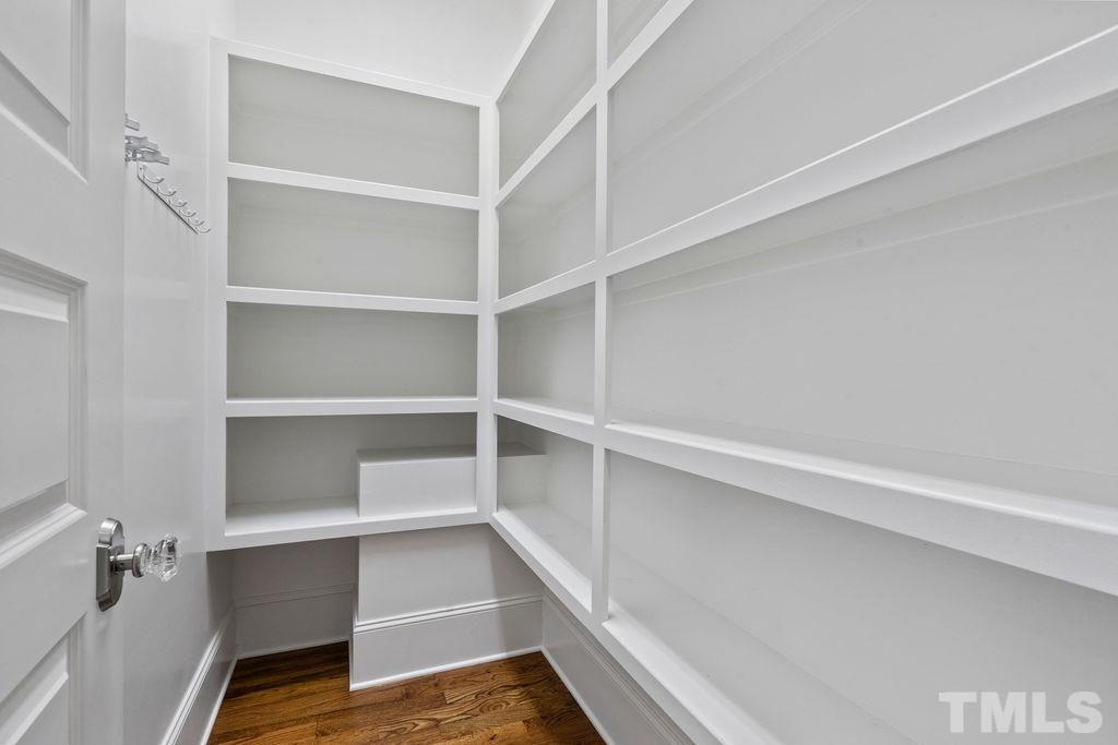 516 Sasser Street Raleigh, NC 27604 - Photo 15 of 30 a view of walk in closet with empty racks