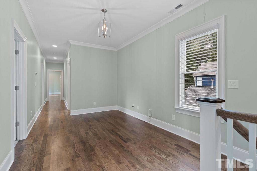 516 Sasser Street Raleigh, NC 27604 - Photo 18 of 30 a view of a hallway with wooden floor and a window