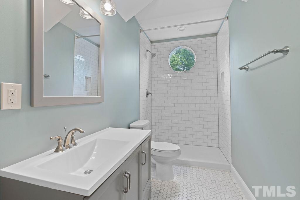 516 Sasser Street Raleigh, NC 27604 - Photo 28 of 30 a bathroom with a sink a toilet and shower