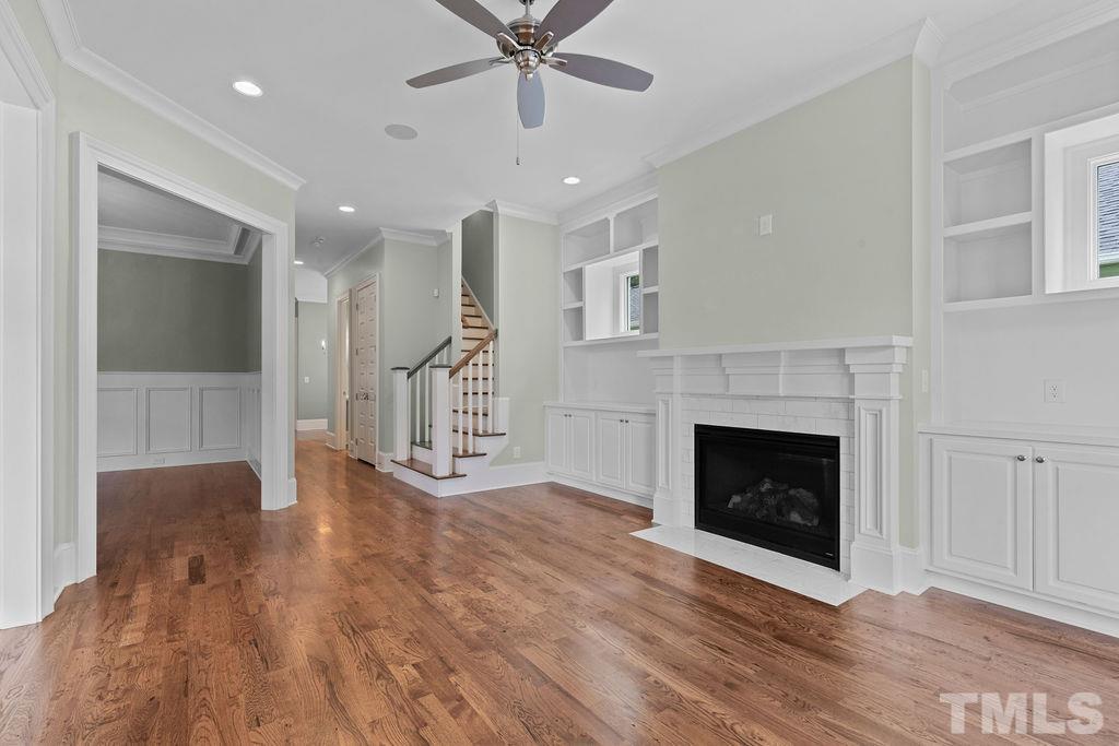 516 Sasser Street Raleigh, NC 27604 - Photo 7 of 30 wooden floor fireplace and windows in an empty room