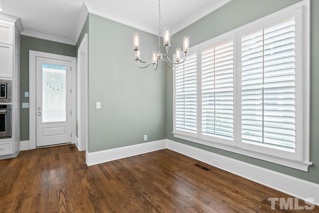 516 Sasser Street Raleigh, NC 27604 - Photo 9 of 30 an empty room with wooden floor and windows
