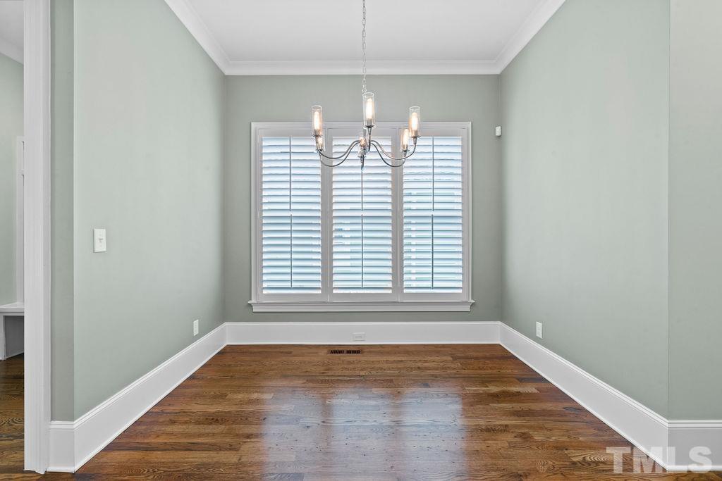 516 Sasser Street Raleigh, NC 27604 - Photo 10 of 30 a view of an empty room with wooden floor and a window