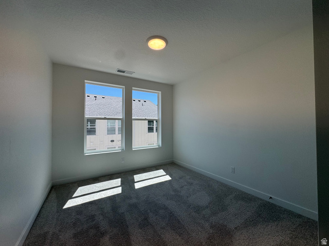 1472 North 1875 West, Unit 151 Layton, UT 84041 - Photo 11 of 20 Dual windows providing ample illumination, plush carpet flooring, white painted walls, white baseboards, and a ceiling-mounted light fixture