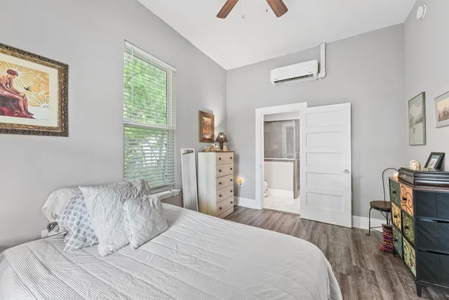 a bedroom with a bed and a flat tv screen