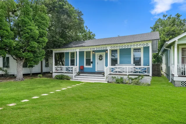 a house view with a sitting space and garden