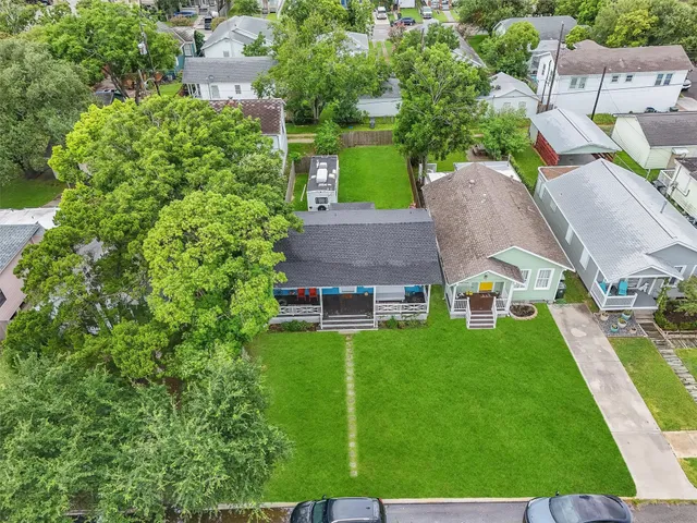 an aerial view of a house with swimming pool garden and patio