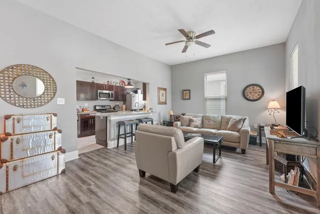 a living room with furniture a fireplace and a flat screen tv