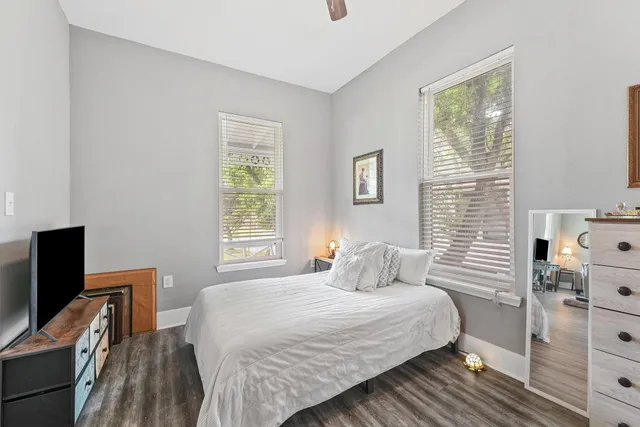a bedroom with a bed and a flat tv screen on a dresser