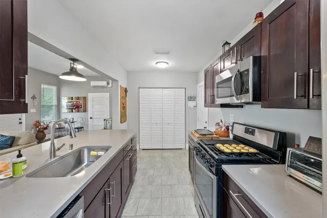a kitchen with stainless steel appliances granite countertop a sink stove and refrigerator