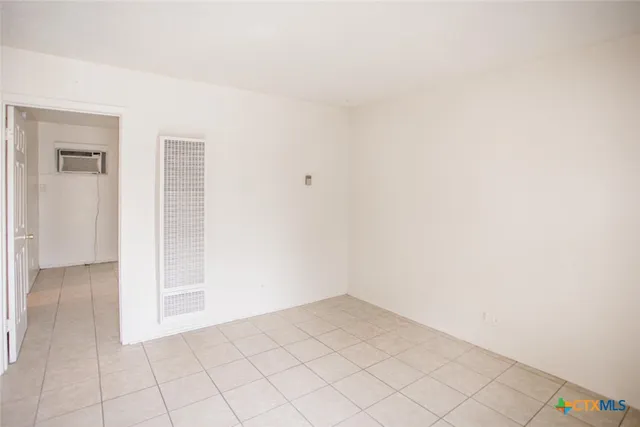 a view of a room with a white wall and utility room