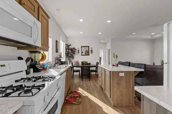 a kitchen with a dining table chairs and refrigerator