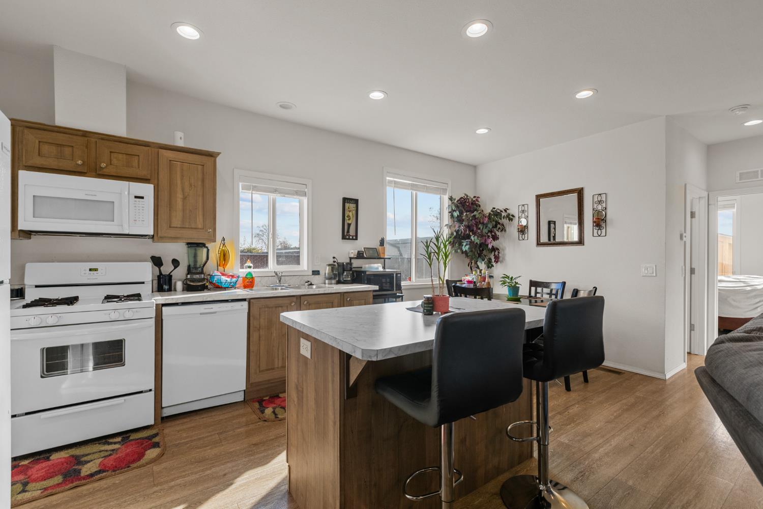 6228 Fowler Avenue Sacramento, CA 95828 - Photo 24 of 47 a kitchen with a dining table chairs and refrigerator