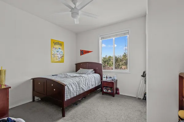 a bedroom with a bed and window