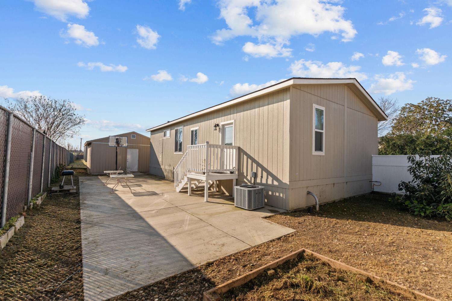 6228 Fowler Avenue Sacramento, CA 95828 - Photo 32 of 47 a white house with a large window and wooden fence