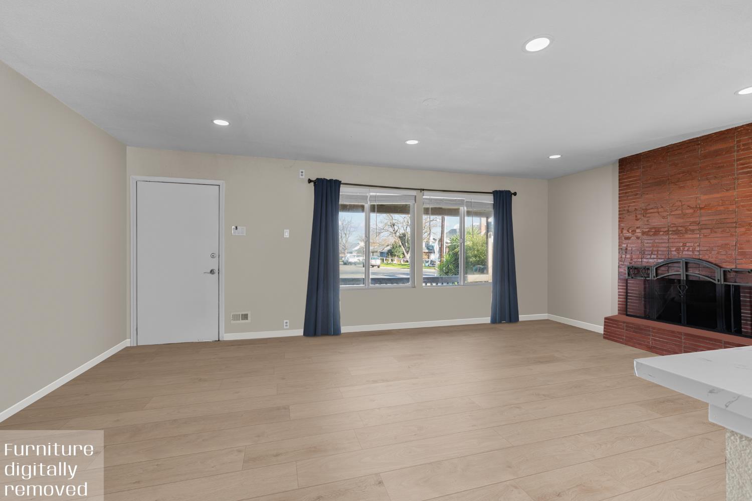 6228 Fowler Avenue Sacramento, CA 95828 - Photo 9 of 47 a view of an empty room with a fireplace and a window