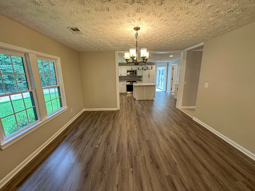 558 Macedonia Road Newnan, GA 30263 - Photo 12 of 44 a view of a room with wooden floor fireplace and windows