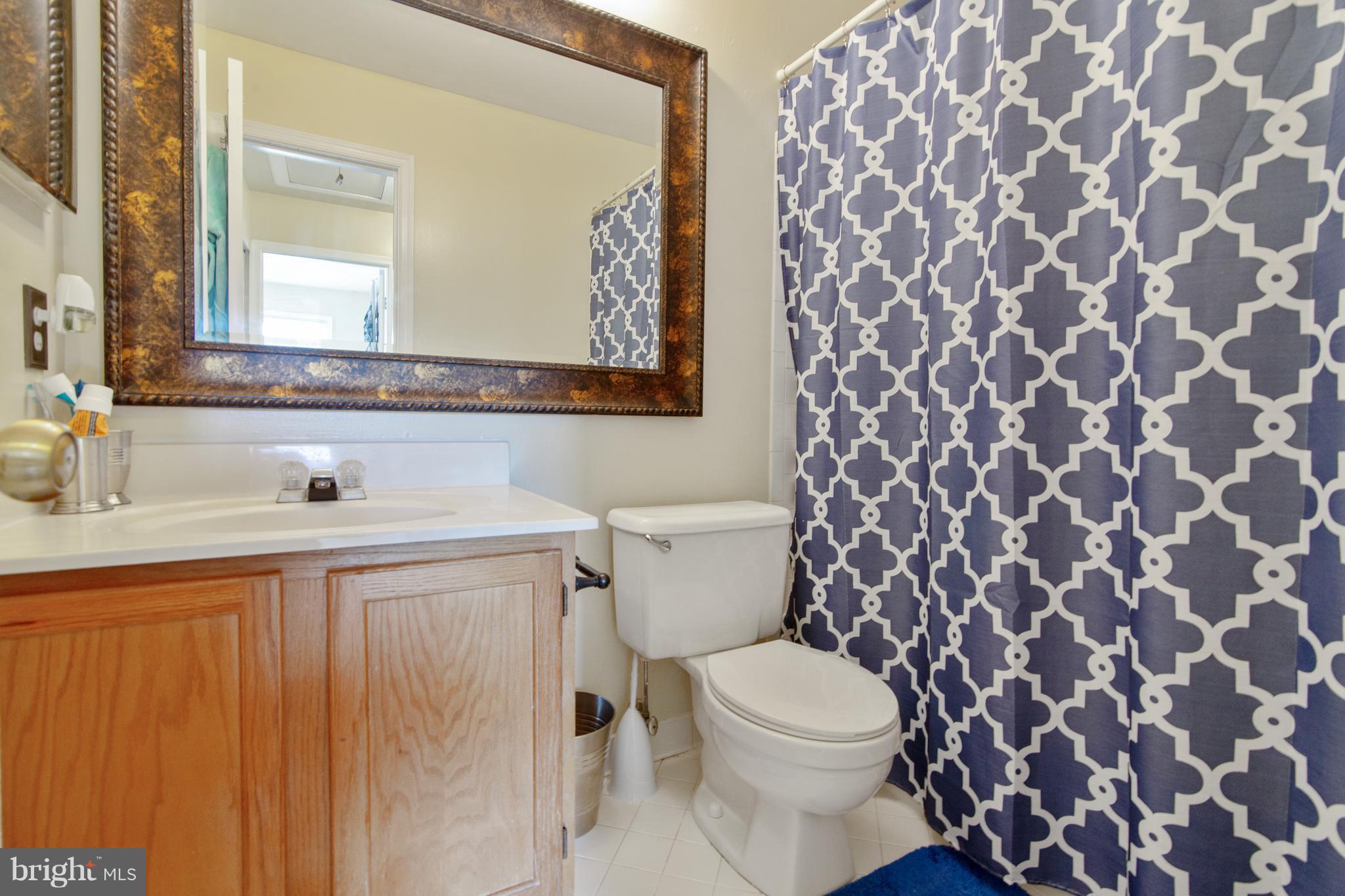 9304 Palmer Place, Unit 5 Laurel, MD 20708 - Photo 27 of 30 a bathroom with a sink and a mirror