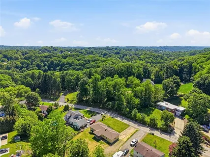 an aerial view of a houses with a yard