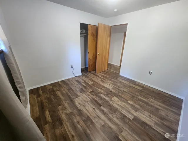 a view of a room with wooden floor and stairs