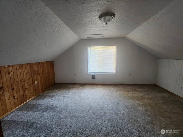 an empty room with a empty space and windows