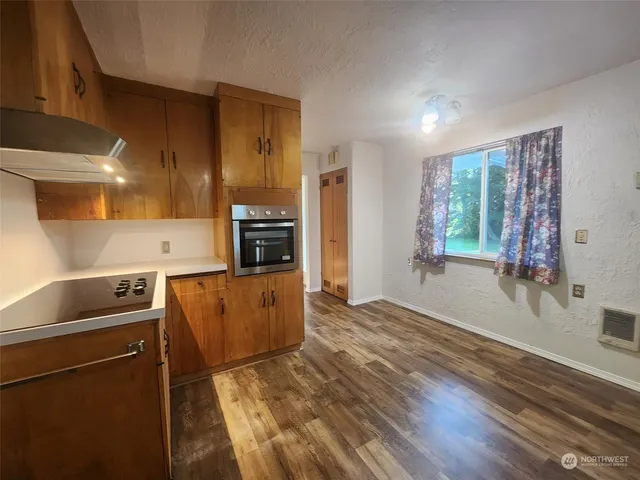 a kitchen with a refrigerator and a stove