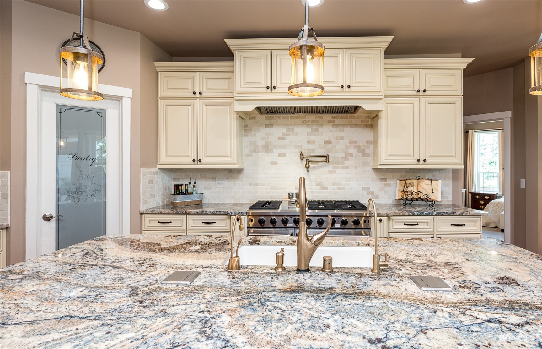 25920 80th Avenue East Graham, WA 98338 - Photo 12 of 40 a kitchen with granite countertop a stove a sink and a white cabinets