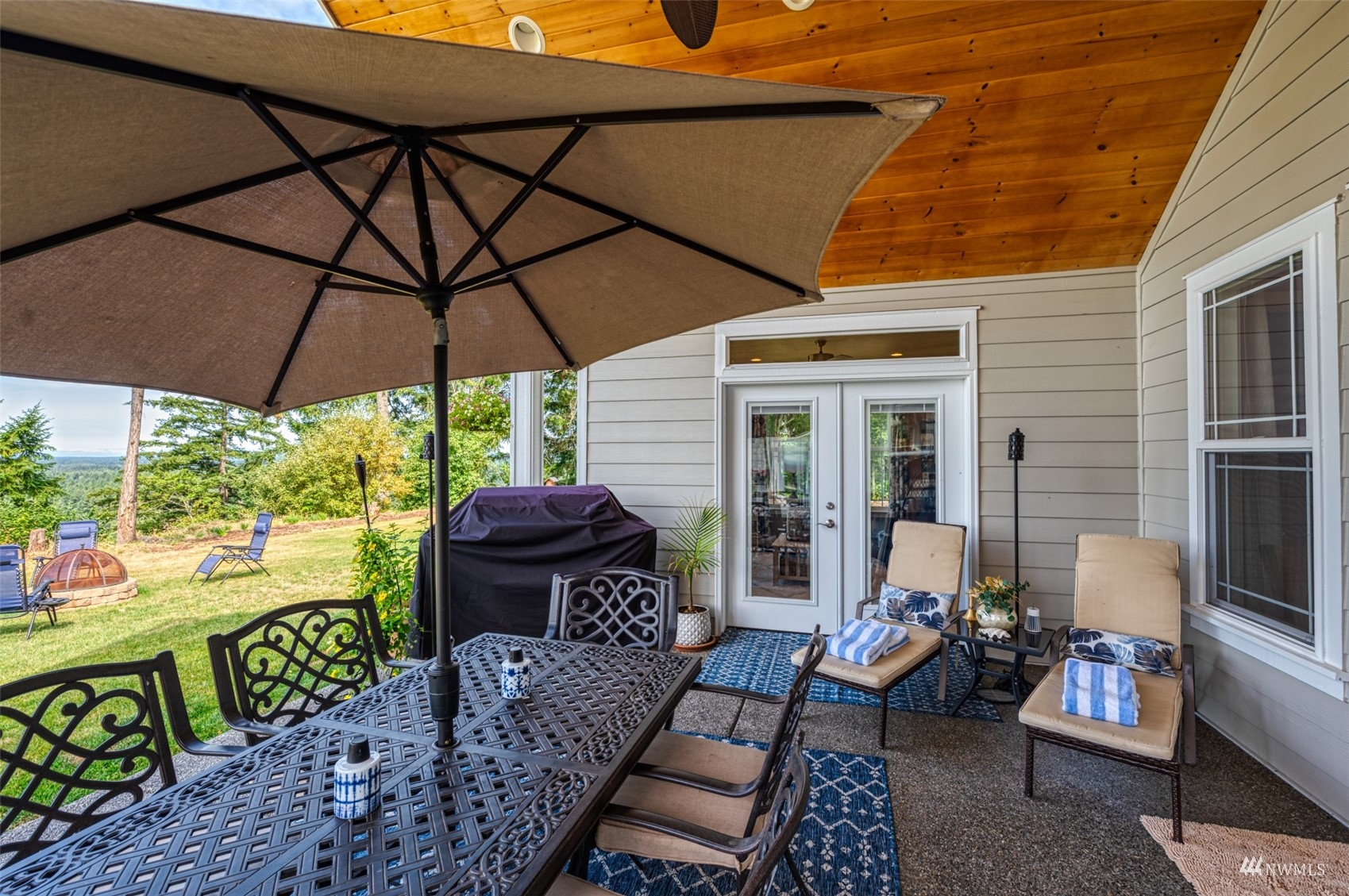 25920 80th Avenue East Graham, WA 98338 - Photo 17 of 40 a view of a patio with couches under an umbrella