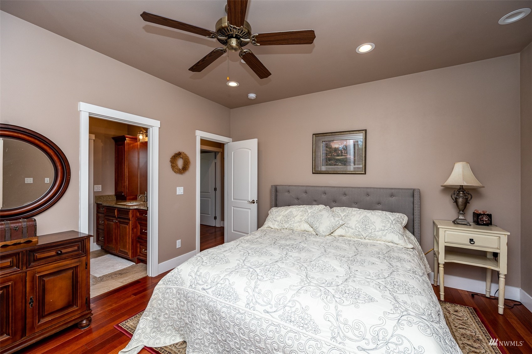25920 80th Avenue East Graham, WA 98338 - Photo 28 of 40 a bedroom with a large bed and a chandelier