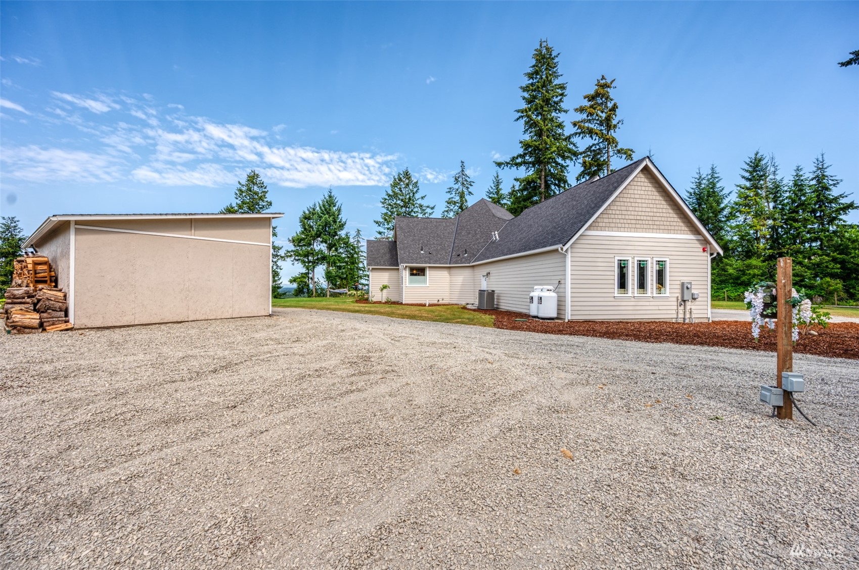 25920 80th Avenue East Graham, WA 98338 - Photo 36 of 40 a front view of a house with a yard and garage