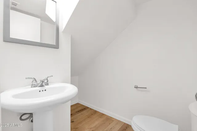 a bathroom with a sink a toilet and mirror