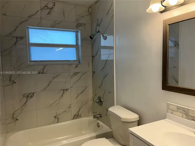 a bathroom with a toilet a sink and bathtub