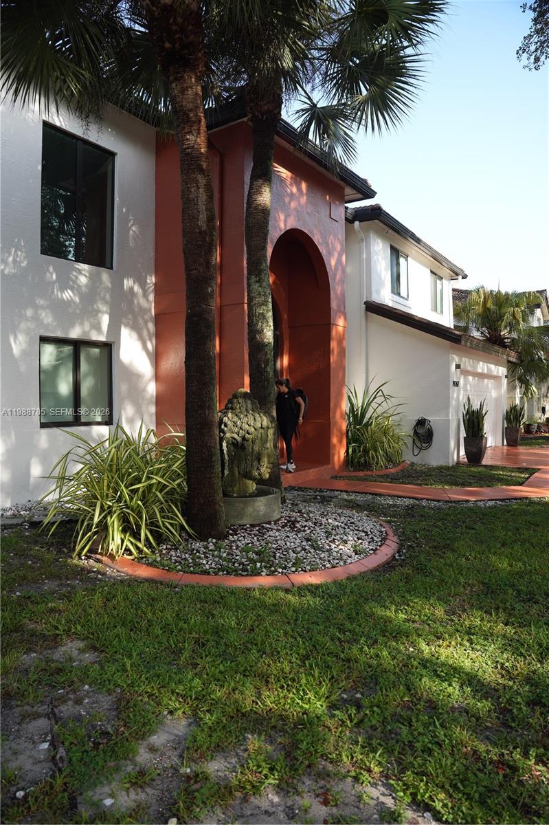 19262 Northwest 89th Avenue Hialeah, FL 33018 - Photo 1 of 20 a front view of a house with garden