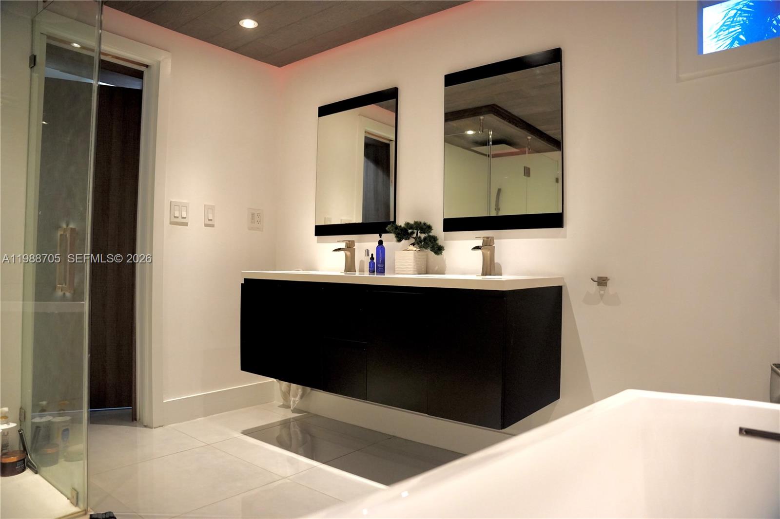 19262 Northwest 89th Avenue Hialeah, FL 33018 - Photo 12 of 20 a bathroom with a sink and a mirror