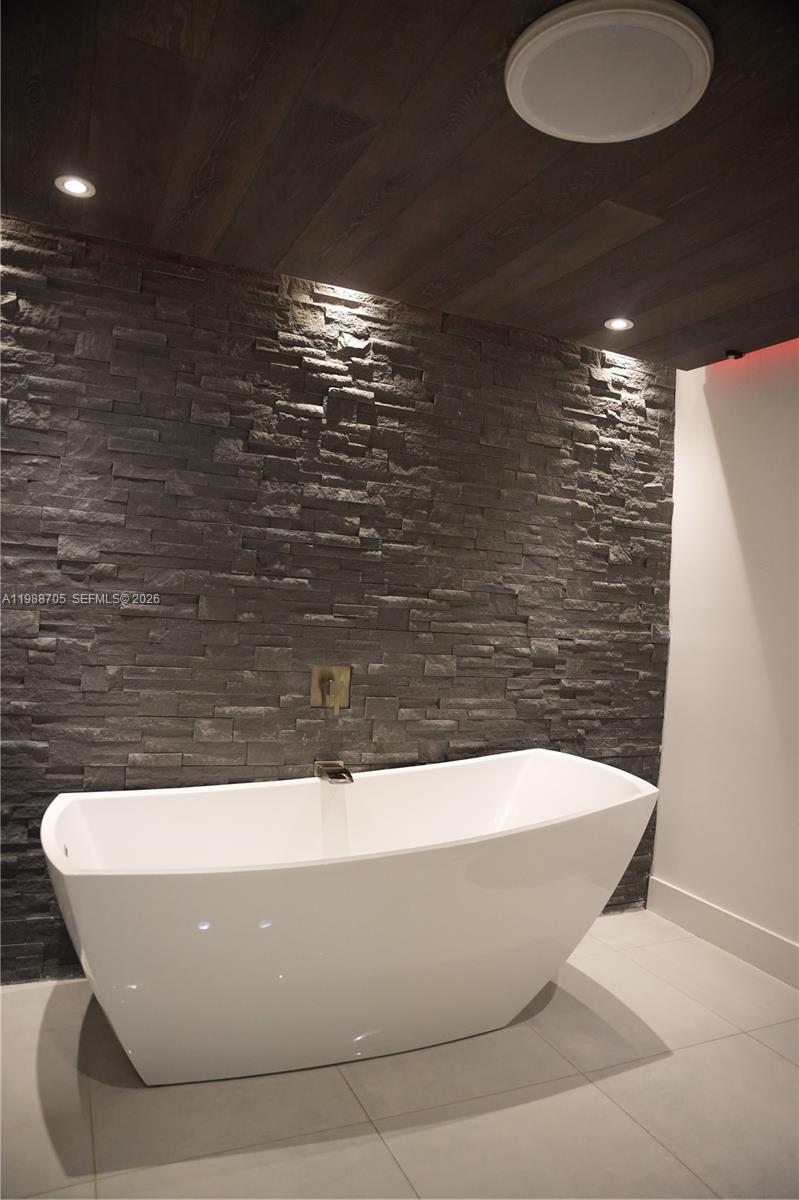 19262 Northwest 89th Avenue Hialeah, FL 33018 - Photo 15 of 20 a white tub sitting in a bathroom